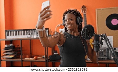 African american woman musician make selfie by smartphone smiling at music studio