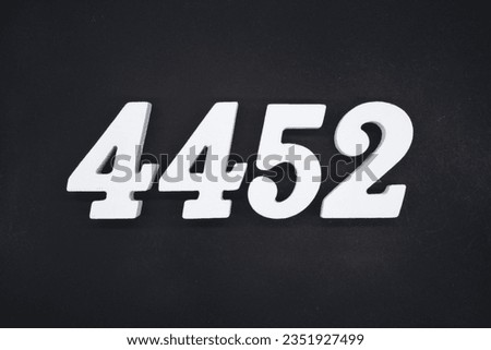 Black for the background. The number 4452 is made of white painted wood.
