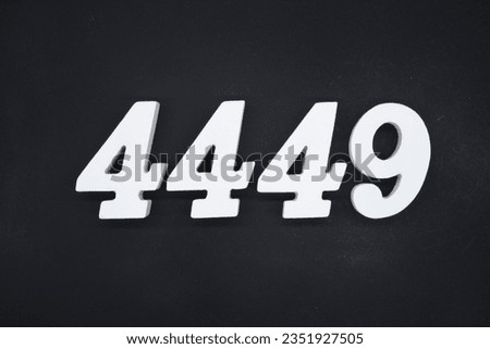 Black for the background. The number 4449 is made of white painted wood. Royalty-Free Stock Photo #2351927505