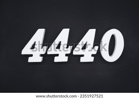 Black for the background. The number 4440 is made of white painted wood.
