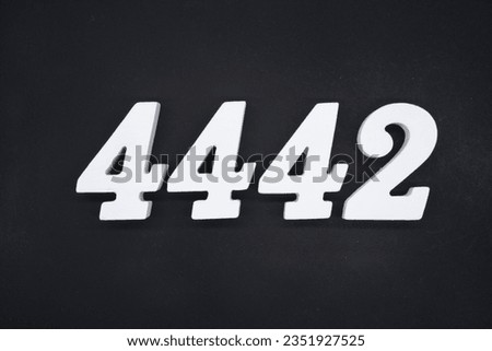 Black for the background. The number 4442 is made of white painted wood.