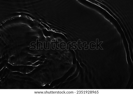 Water black surface abstract background. Waves and ripples texture of cosmetic aqua moisturizer with bubbles
 Royalty-Free Stock Photo #2351928965