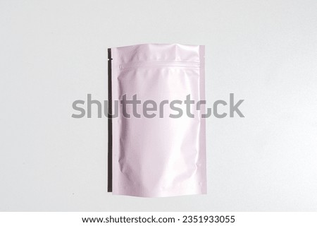 Pink storage bag with metallic texture with zip lock lock. Food bags made of aluminum foil, packaging bags with a zipper flap, for snacks, tea, self-closing bags made of mylar with a zipper Royalty-Free Stock Photo #2351933055