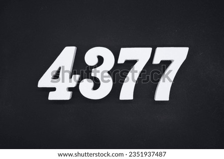 Black for the background. The number 4377 is made of white painted wood.