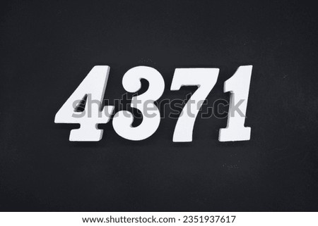 Black for the background. The number 4371 is made of white painted wood.