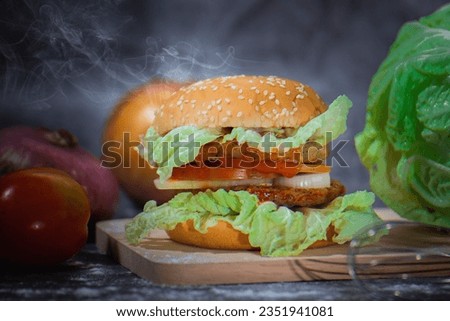 Pork burger with veggies, dark background, smoke