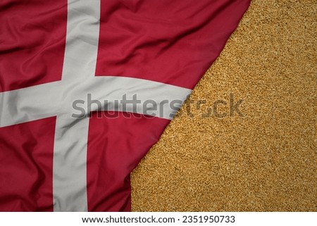 wheat grain on the waving colorful big national flag of denmark .macro shot.