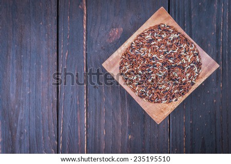 Rice brown on wooden background - vintage effect stlye picture