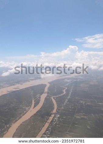 Aerial view from airplane of field and villages of Mekong Delta in South Western Viet Nam near Can Tho city on a cloudy day