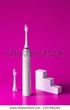 Dental care concept. Ultrasonic toothbrush and clear replacement with white podium on magenta background