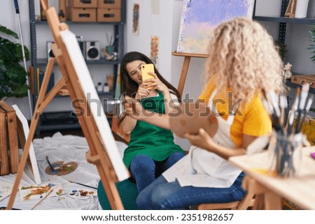 Two women artists make photo by smartphone drawing at art studio