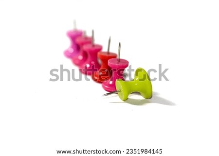 Pin red and green color put on white background in isolated picture.