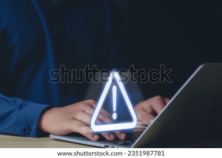 Businessman or employee with triangle warning sign for error warning Hack Alert System Warning Cyber Attack