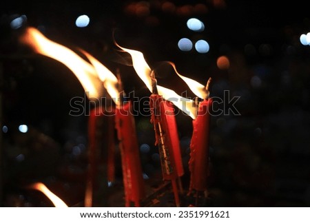 close-up photo of red candles which the Chinese used to worship the goddess which clearly separate colors White candles for funerals, mourning, yellow candles for paying homage It is a culture that va
