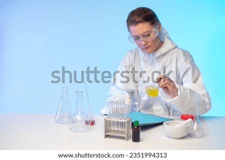 Doctor in laboratory. Woman virologist. Laboratory assistant at table with test tubes. Doctor examines active ingredients drugs. Medic comes up with new drug. Woman doctor doing laboratory experiment Royalty-Free Stock Photo #2351994313
