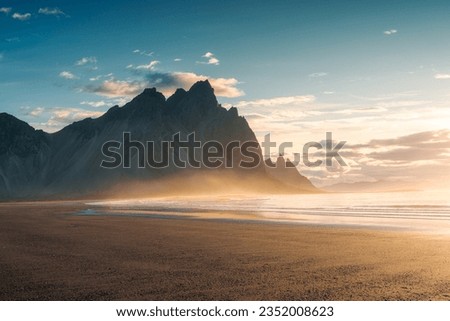 Beautiful view of sunrise over Vestrahorn mountain on black sand beach in summer at Stokksnes peninsula, Iceland Royalty-Free Stock Photo #2352008623