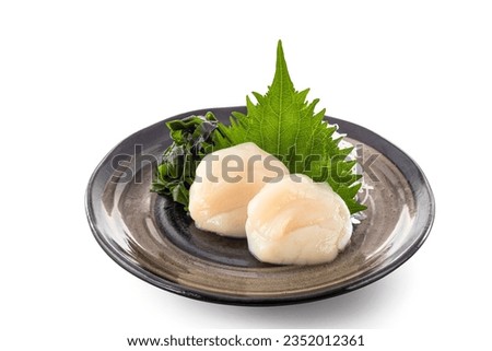 Fresh raw japanese scallop or Hotate sashimi in japanese style in ceramic plate isolated on white background. Royalty-Free Stock Photo #2352012361