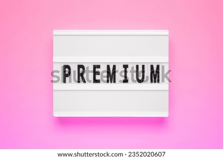 The word premium on lightbox isolated pink background. Premium Membership Concept.