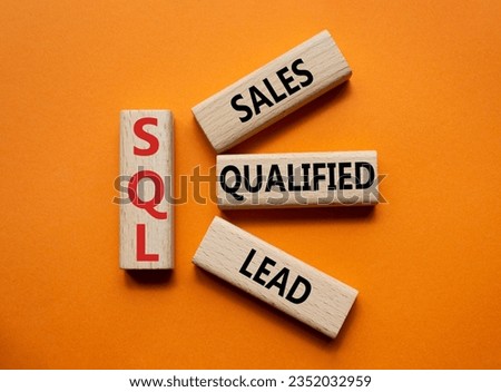 SQL - Sales Qualified Lead. Wooden cubes with words SQL. Beautiful orange background. Business and SQL concept. Copy space. Royalty-Free Stock Photo #2352032959