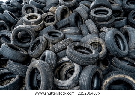 Old tires trash storage. Used tires at recycling garbage field. Royalty-Free Stock Photo #2352064379