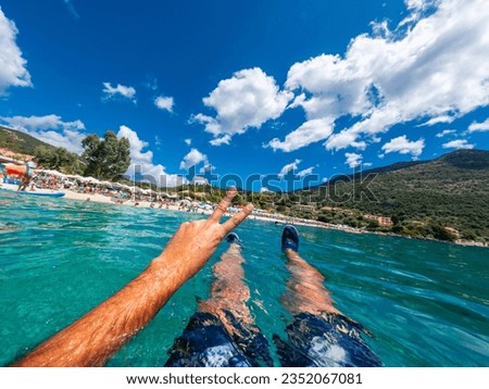 Resting in the sea on the beach in summer of Paralia Mikros Gialos in the south of the island of Lefkada. Greece.