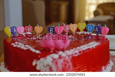 Birthday cake candles that say Happy Birthday.