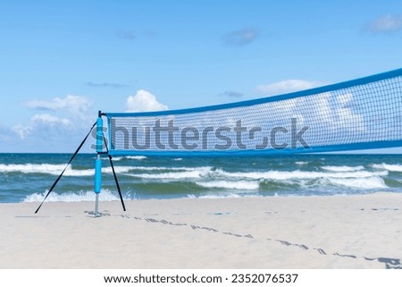 Beach volleyball and beach tennis net on the background of sand. Horizontal sport theme poster, greeting cards, headers, website and app
