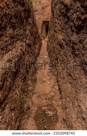 Narrow passage between rock-hewn churches in Lalibela, Ethiopia Royalty-Free Stock Photo #2352098745