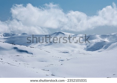 Clouds on a sunny day in distance in backcountry in Charlotte's Pass ski resort in New South Wales in Australia Royalty-Free Stock Photo #2352101031