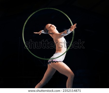 Dance, training with a gymnastics hoop and a woman in the gym for a performance showcase or practice. Fitness, energy and concert with a female athlete on a dark background for routine or recital