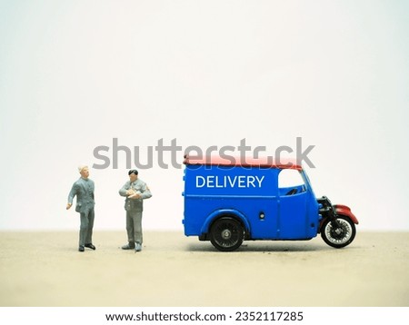 Mini toy at table with blurred background. Delivery service concept design.