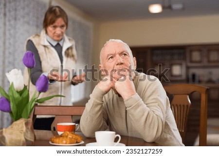 Elderly couple quarreling at home. High quality photo