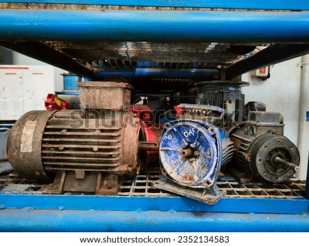 Piles of used electromotors are stored in a special rack Royalty-Free Stock Photo #2352134583