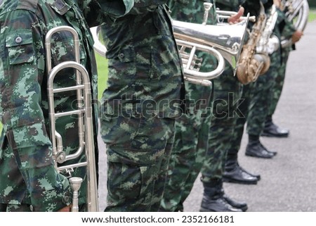 army musician holding a musical instrument outdoors