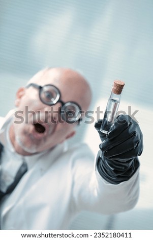 Evil bald professor brandishes a vial, planning world control. His glasses, black gloves, and intellect promise victory over naysayers. Ultimate evil looms