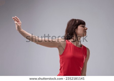 Vain and finicky woman, deeply irritated, repels something beneath her standards. 'Disgusting and irreverent!" she thinks. She gestures to push away the offending item, showing clear disgust Royalty-Free Stock Photo #2352181141