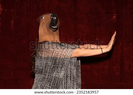 Photo Booth. Unidentifiable People wear Horse Head Masks and pose and play while their pictures are taken in a Photo Booth. Party Photo Booth. Wedding Photo Booth. Holiday. Horsing Around. Fun 