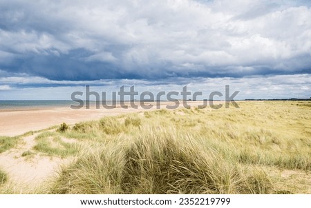Dark clouds roll over the beach and sand dunes at Titchwell on the North Norfolk coast pictured in August 2023.