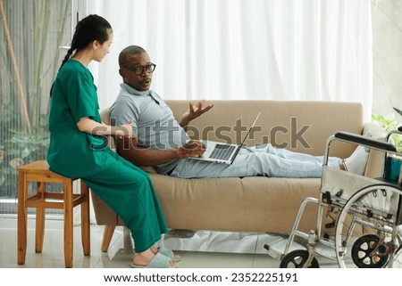 Man with disability complaining to social worker visiting him at home