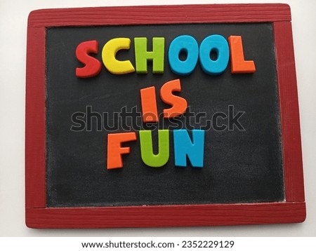 school is fun written with colorful letters on a chalkboard 