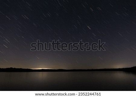 Night with moving stars in the Valparaíso Reservoir, Zamora, Spain.