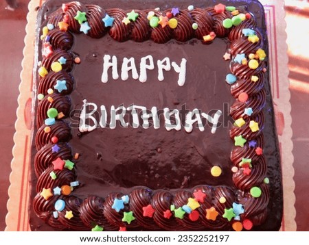 Chocolate birthday cake. Chocolate cake with the inscription "Happy Birthday". Top view of a birthday cake.                               