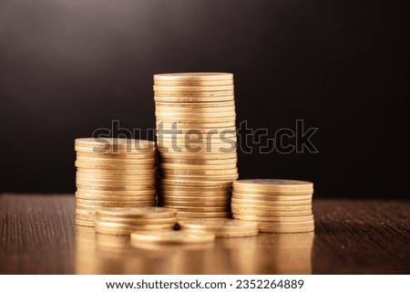 Closeup of coin pile at dark background