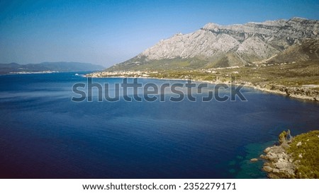 St. Elijah mountain rising high above town of Orebic on Peljesac peninsula, overlooking island of Korcula in the distance, photographed with drone Royalty-Free Stock Photo #2352279171