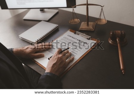 Lawyer sits in office with litigation contract documents, attorneys draft contracts and legal terms for clients for litigation, fair and transparent litigation. Lawyer concept and litigation.