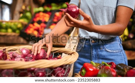 Close Up Of Female Customer At Market Stall Choosing Red Onions