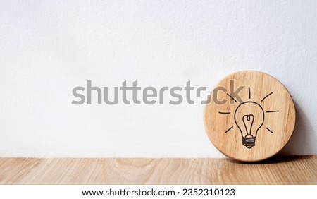 creative and innovative education concept image light bulb icon on wooden circle with white background and copy space.