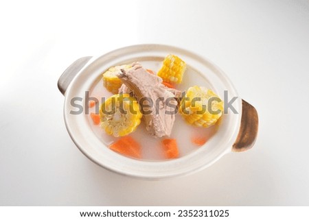 chef double boiled pork ribs meat with corn and carrot chicken stock hot soup in clay pot on white background asian halal food Chinese banquet menu for restaurant