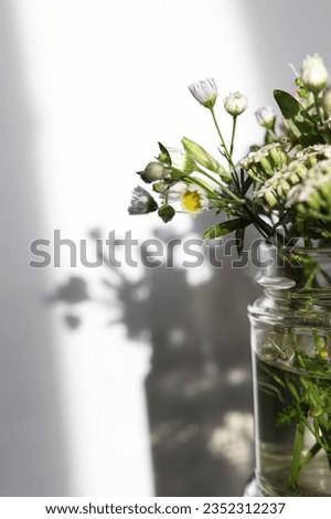 selective focus wild flowers in a glass jar in the sun
