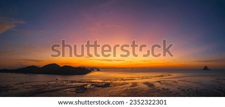 Aerial view stunning sky at sunrise above Ko Yao Noi island.
Wonderful aerial view of colorful landscape during the sunrise. 
Flying over Laem Had sand beach. Sky texture, abstract nature background.